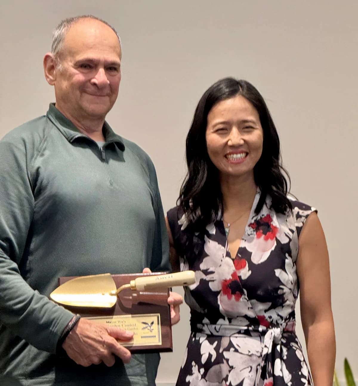 Franco Campanello stands beside Mayor Michelle Wu holding his Golden Trowel award