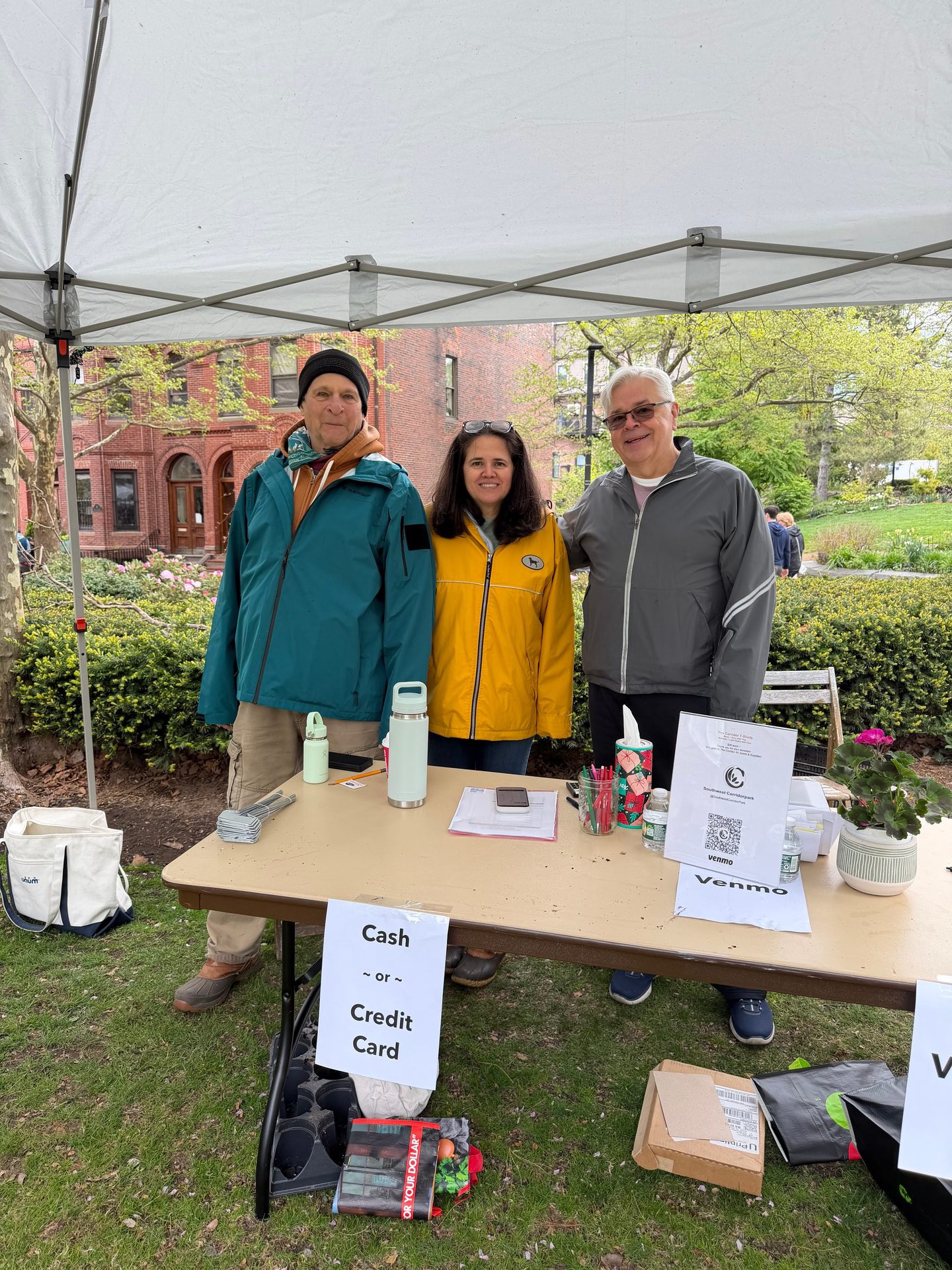 Volunteers at the cashier table with payment signs