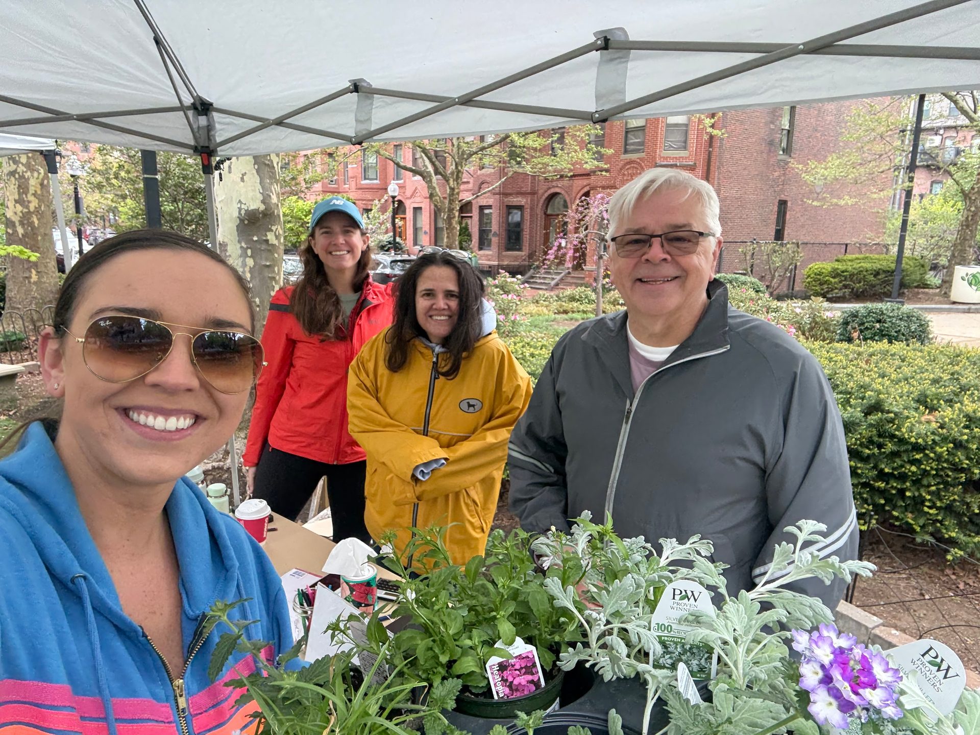 Volunteers posing with plants at the sale
